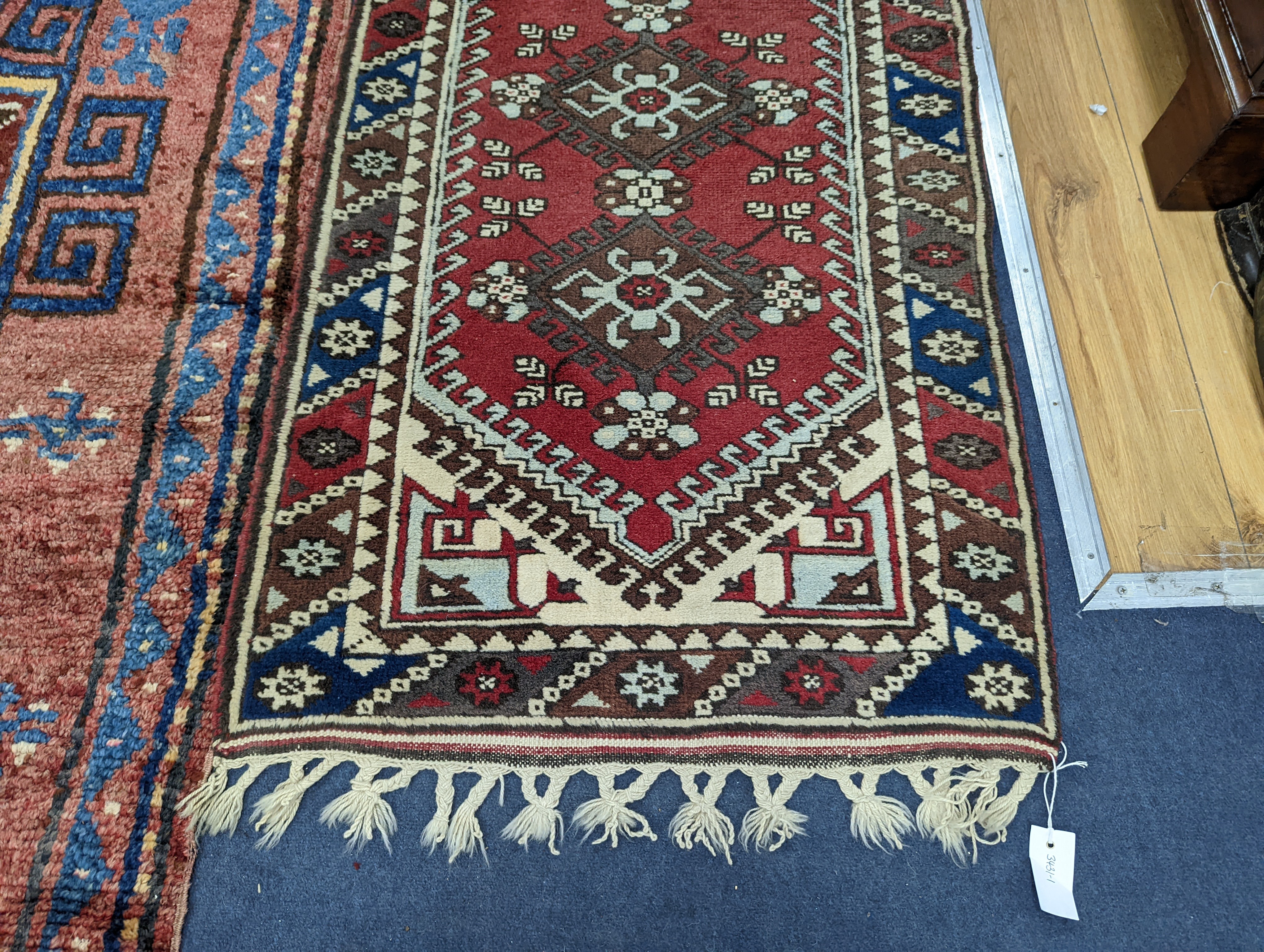 A Caucasian design red ground runner, 300 x 78cm